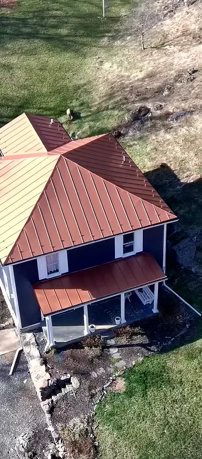 Aerial drone view of a completed standing seam metal roof by Mantle Roofing in Virginia