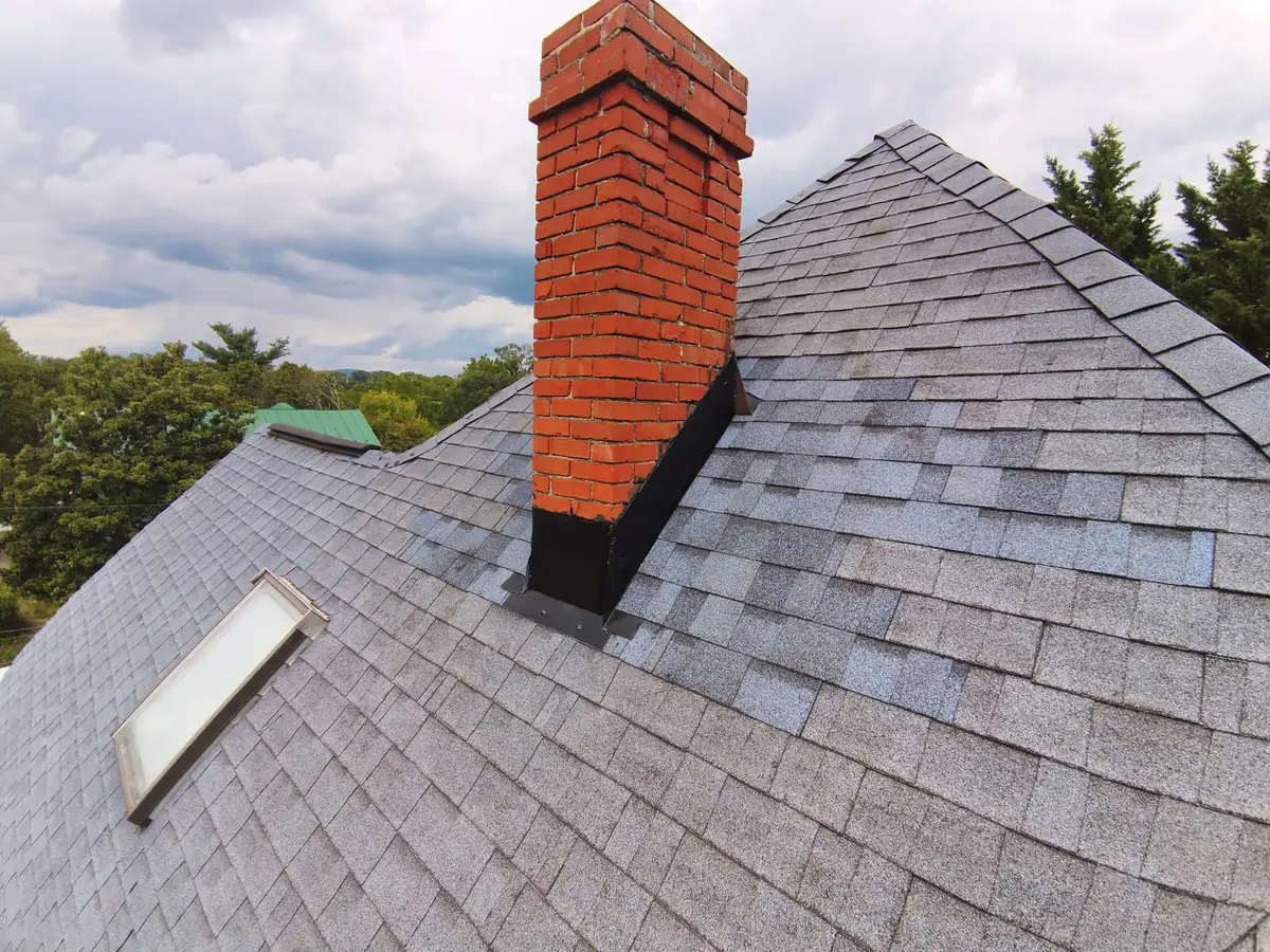 Mantle Roofing repairing chimney flashing on a shingle roof in Virginia