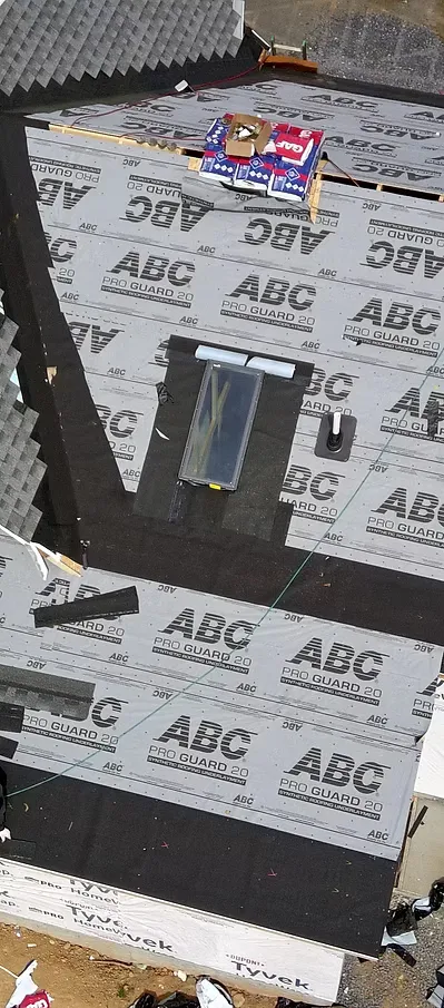 Mantle Roofing crew installing synthetic underlayment during a roof replacement in Virginia