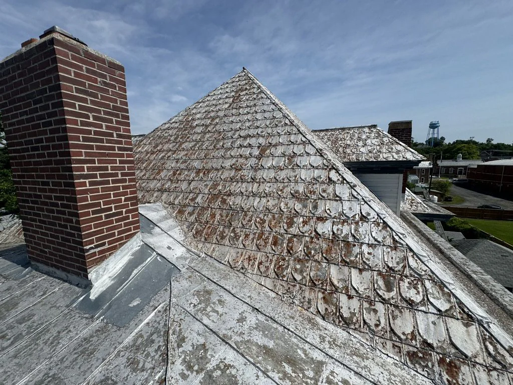 Existing weathered metal shingle roof before the Strasburg roofing project
