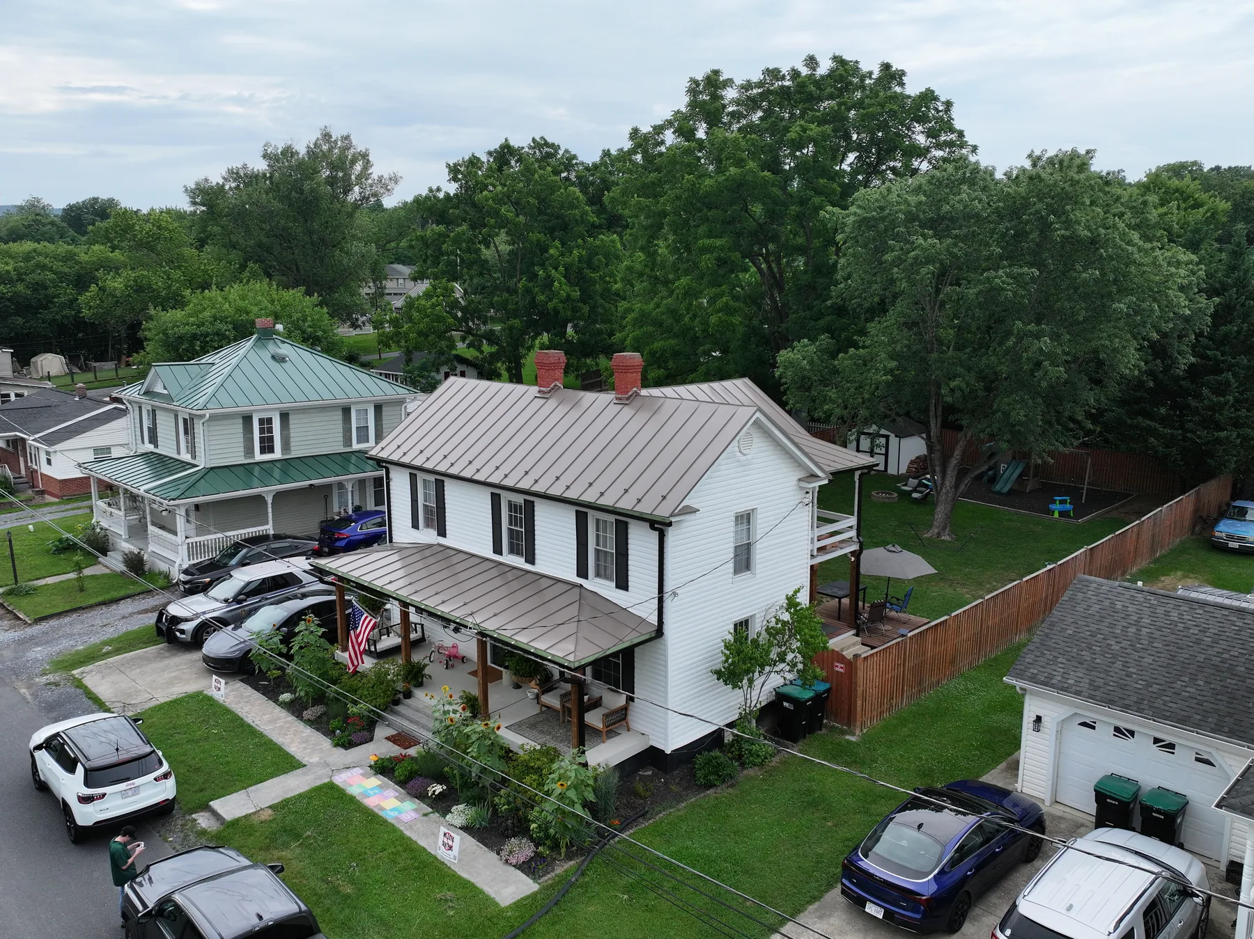 Angled aerial view of the new metal roof and siding on a Woodstock home
