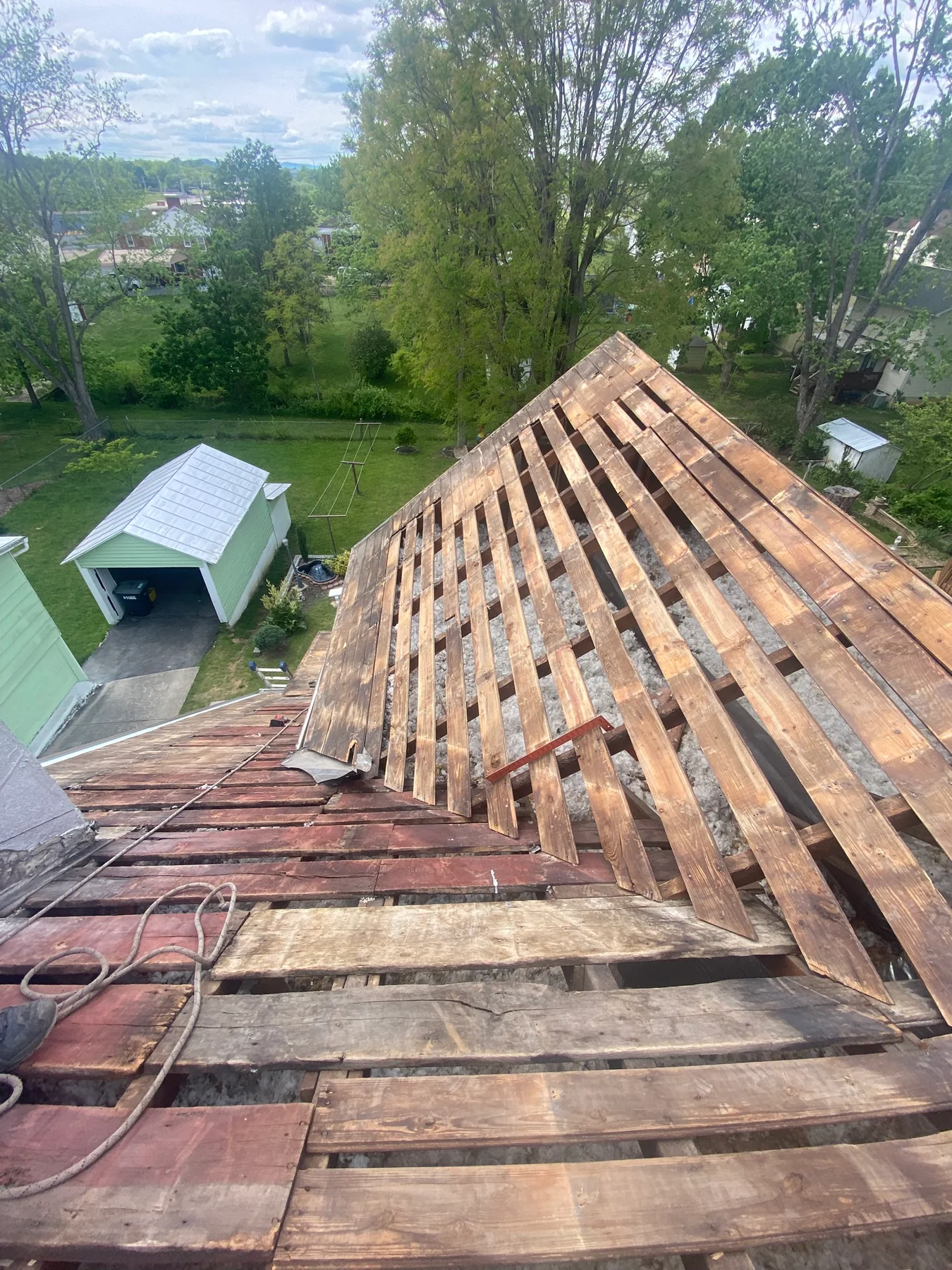Wood roof deck exposed during tear-off for a Harrisonburg metal roof replacement